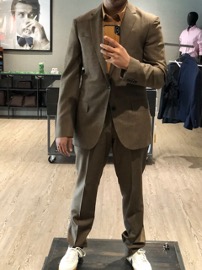 Photo of a man in a suit before an alteration